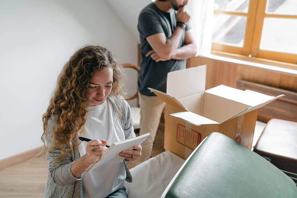 A man and a woman going over everything they've packed