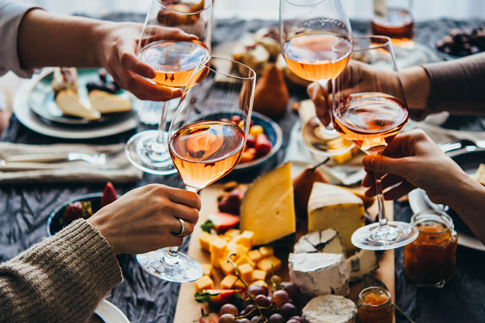 People cheering with wine glasses 