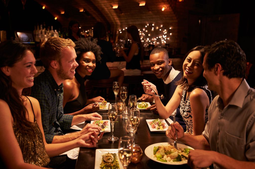 A group of people sitting at a dinner table