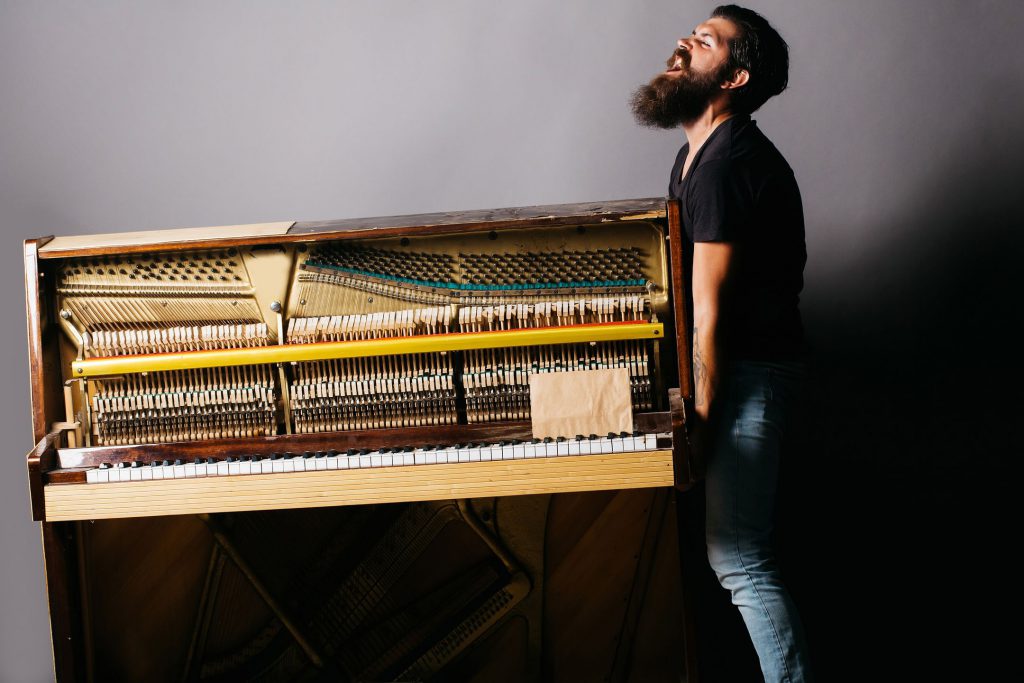 A man trying to lift the instrument
