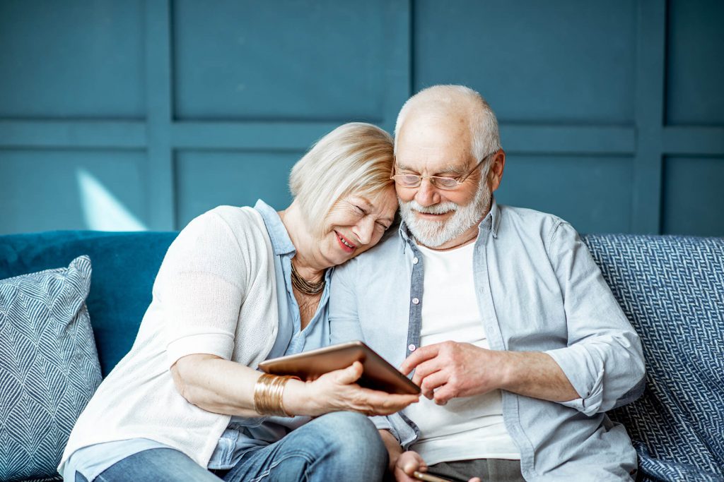 An older man and woman on a couch