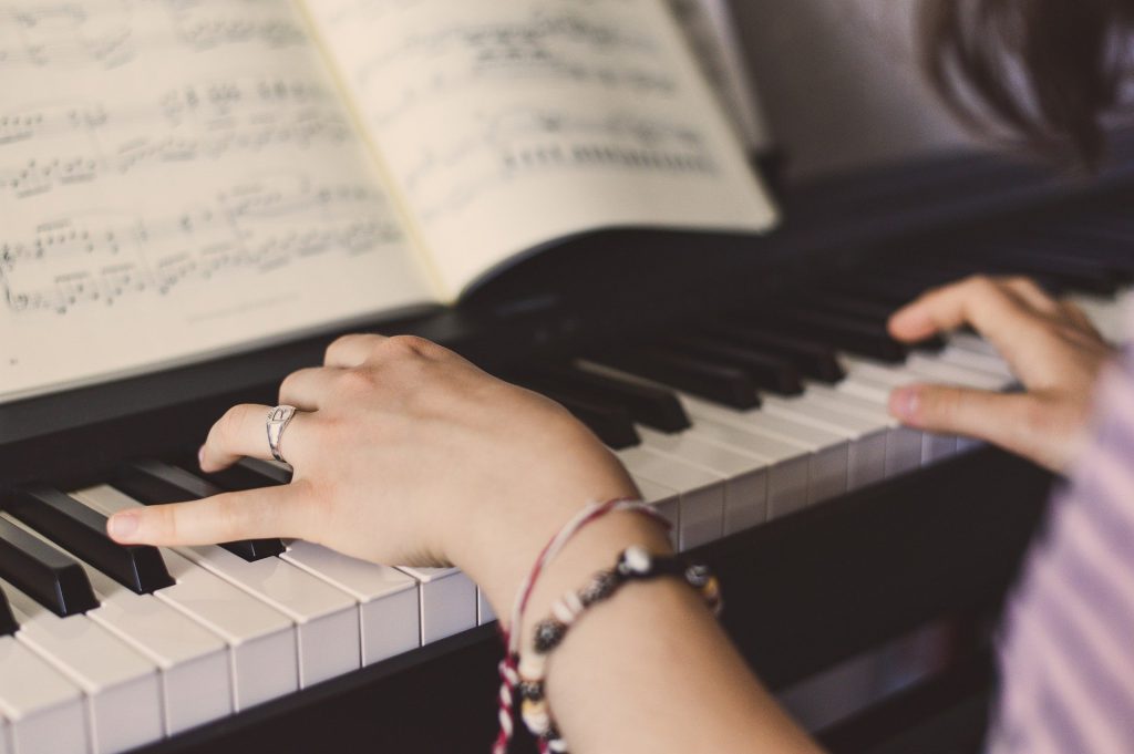 Close view of the woman playing a keyboard