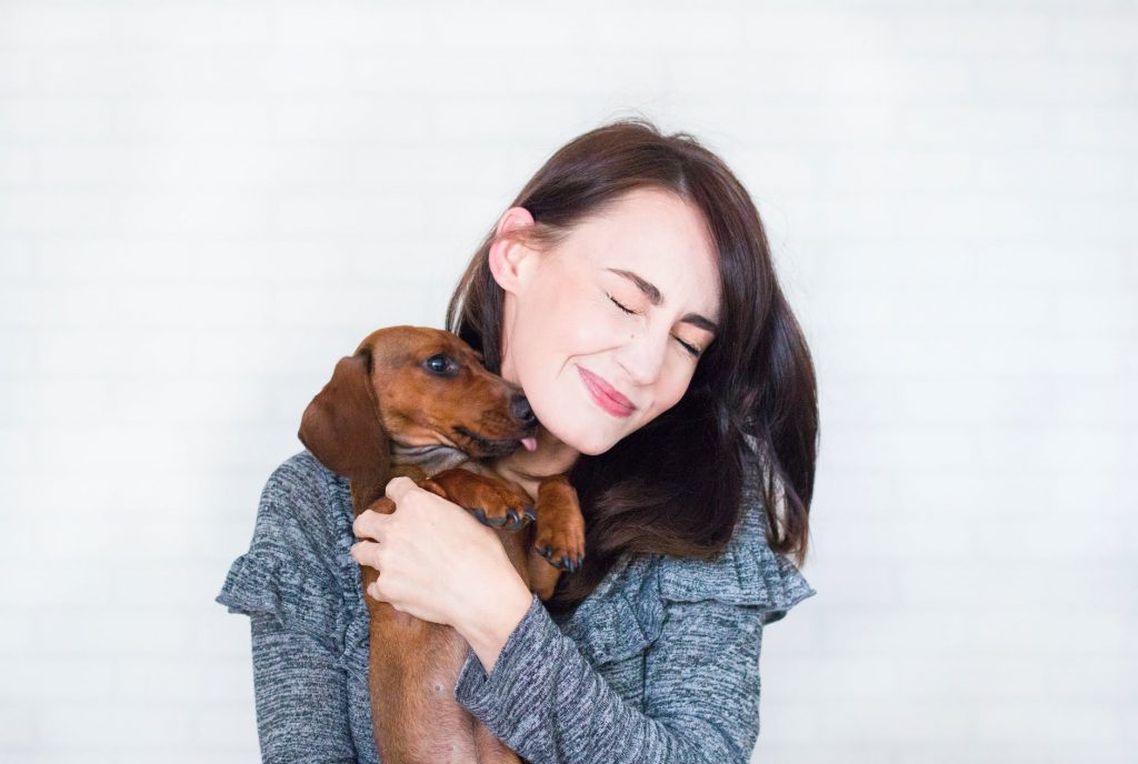 A girl holding a dog