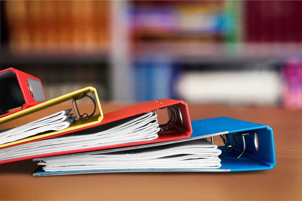 Yellow, red, and blue binder on the desk