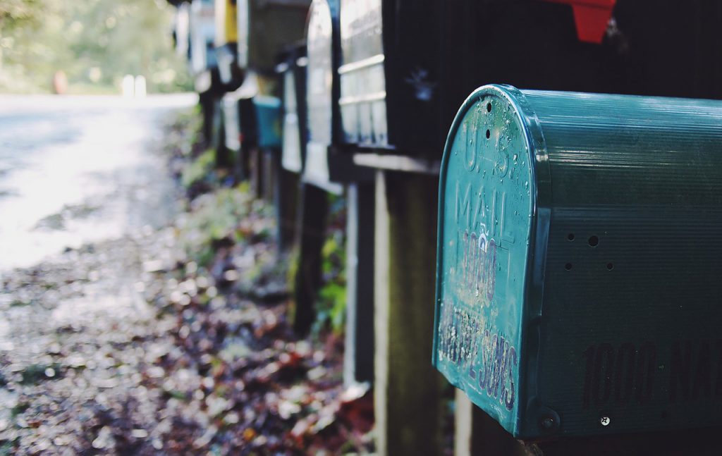 Blue postbox, and a row of other postboxes behind it