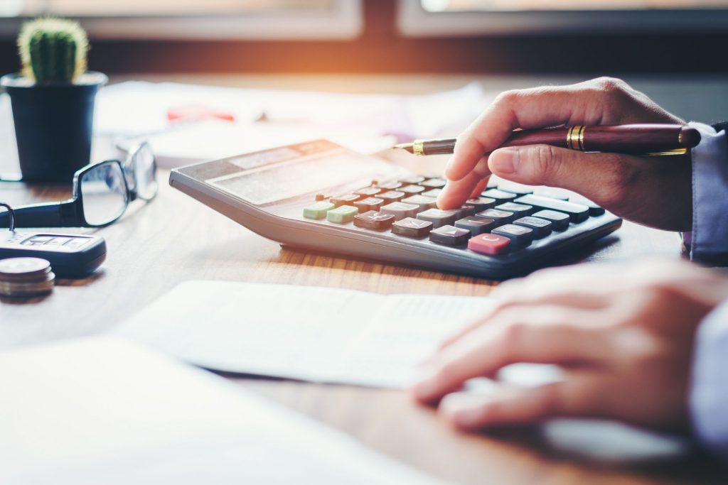 Person calculating expenses and thinking about benefits of moving