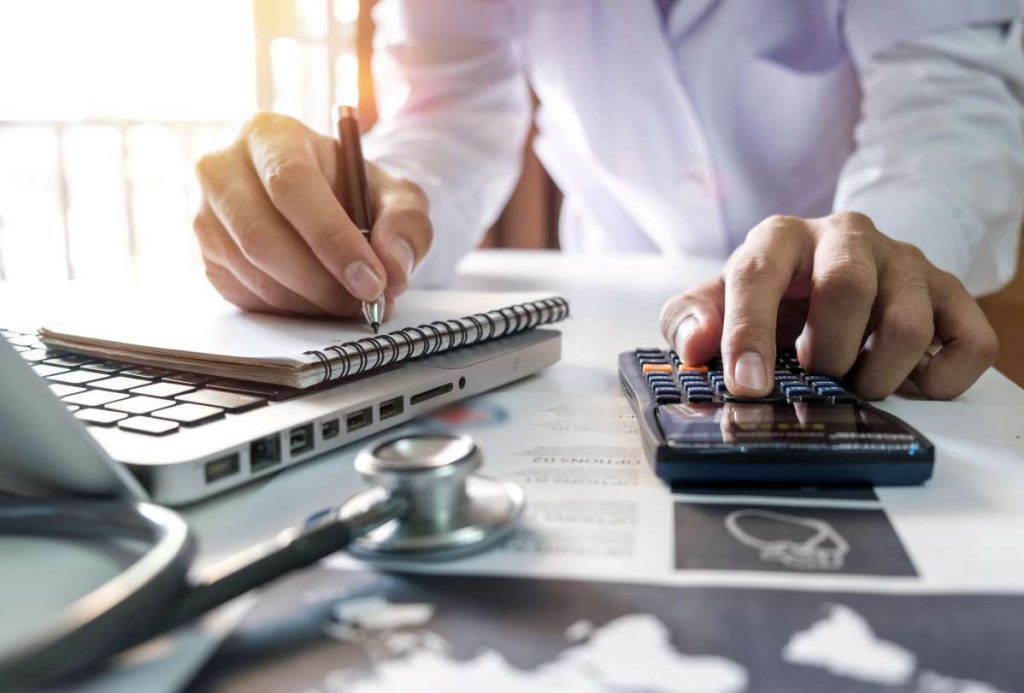 A person calculating their expenses before Chicago movers relocate them.