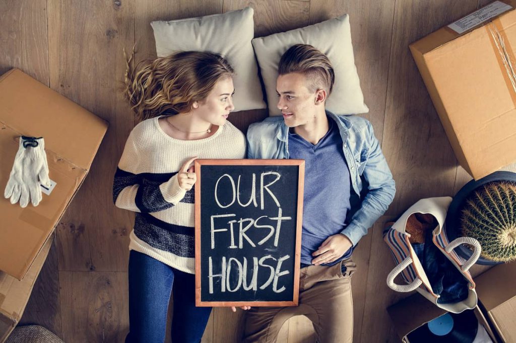 Couple lying on the floor of their first apartment