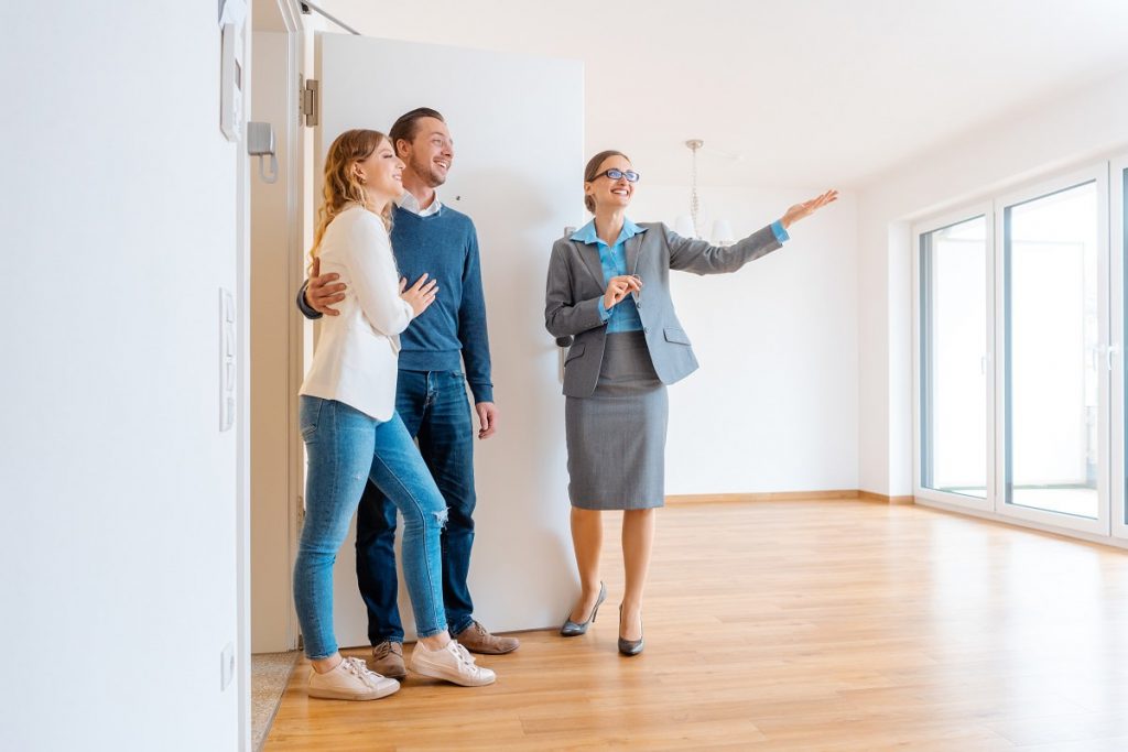 Couple choosing apartment with a real estate agent