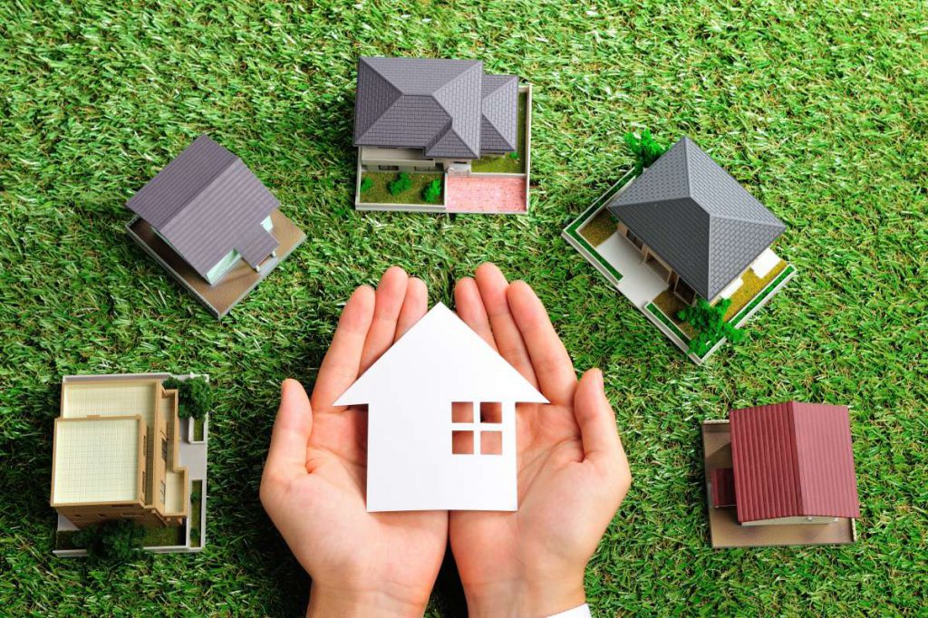 Multiple models of houses on a green lawn