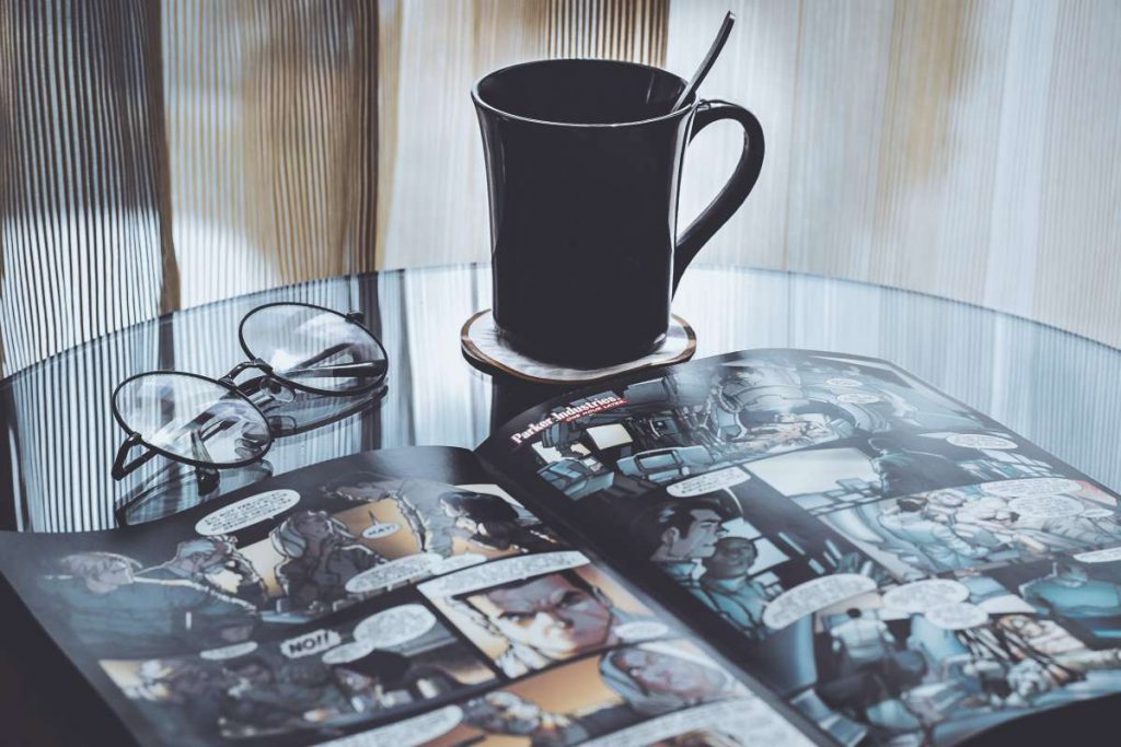 A glass table with an open comic book