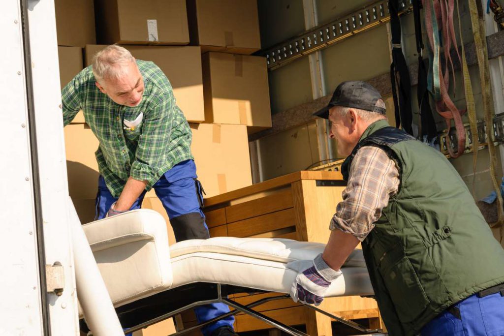 Chicago movers loading a chair into the truck