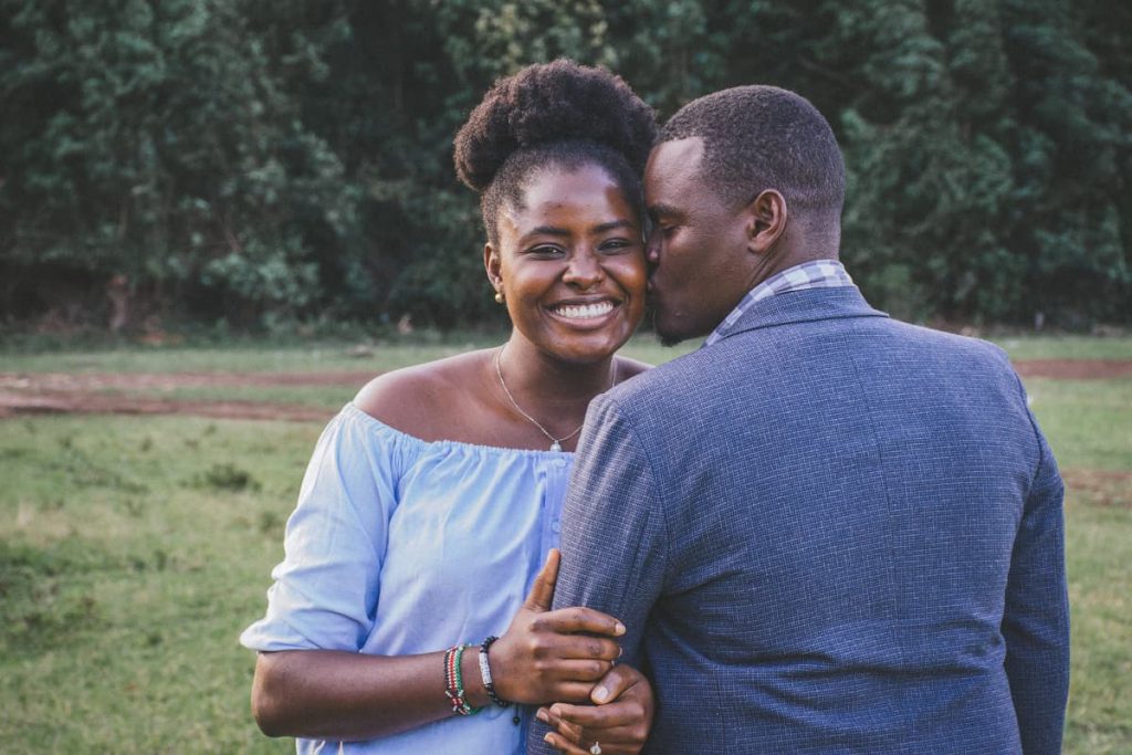 A man kissing a woman on the cheek