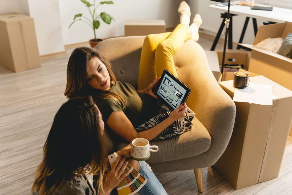 Two girls talking about Chicago moving companies while they research the city