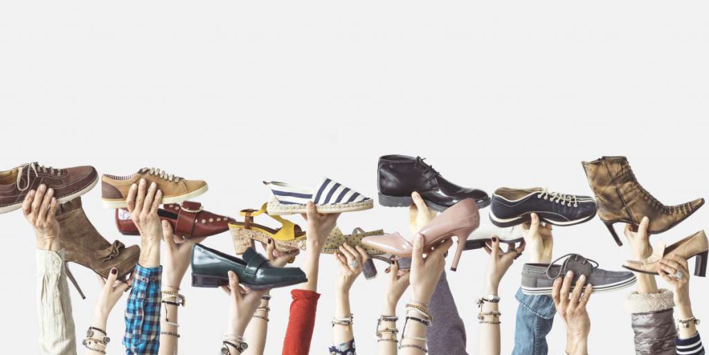 Hands holding footwear