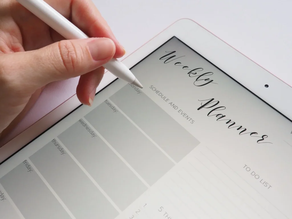 person writing a plan in notebook
