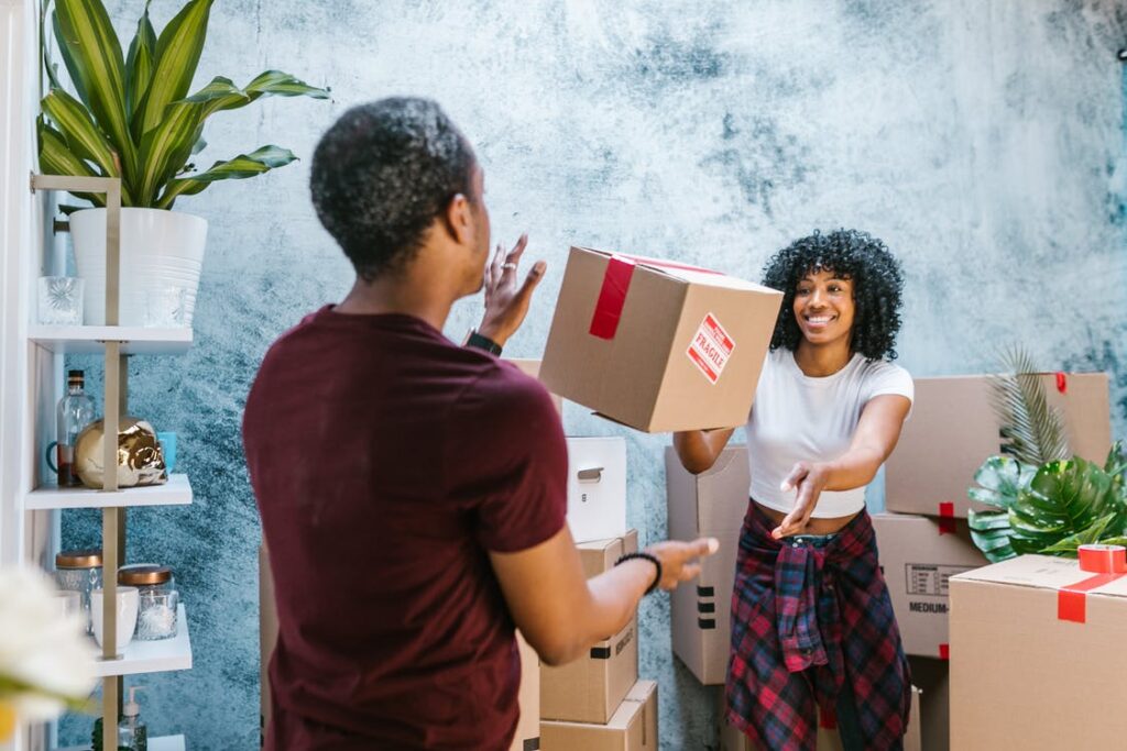 girl trowing a box to a man