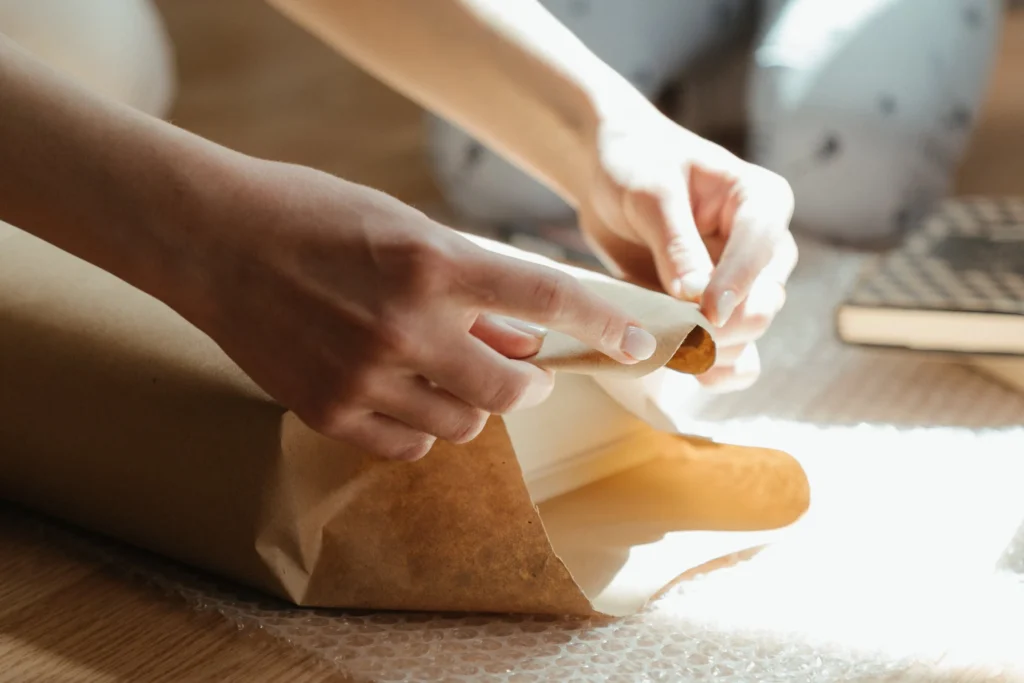 Woman wrapping a book in packing paper